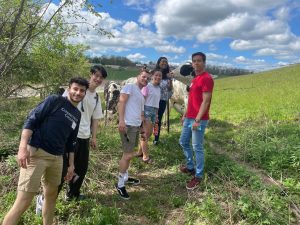 ISSS Grad Buddies Posing with Cow at Horsebarn Hill